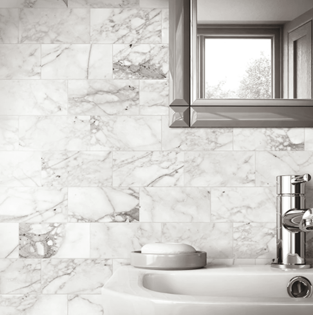 A bathroom with a sink and mirror in it