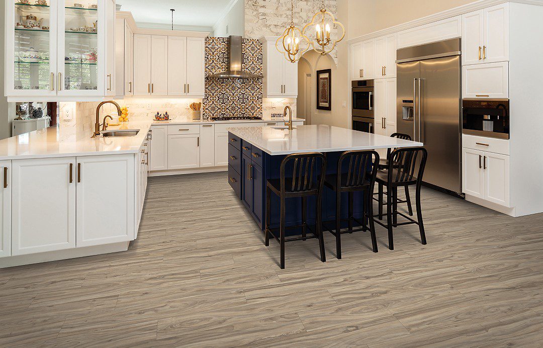 A kitchen with white cabinets and black island.