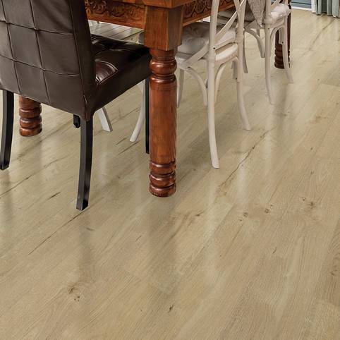 A dining room table and chairs in front of a wooden floor.