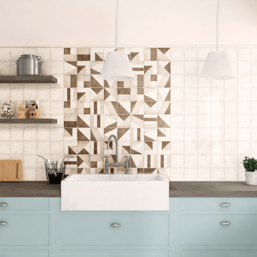 A kitchen with blue cabinets and white tile walls.