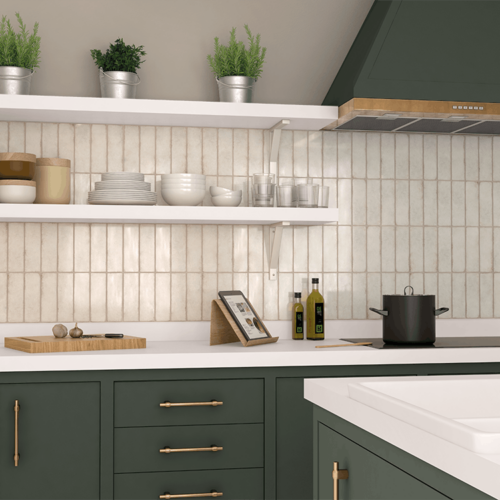 A kitchen with green cabinets and white counters.