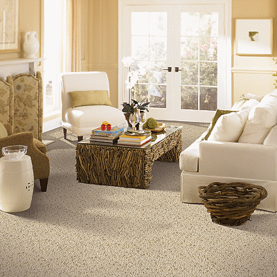 A living room with white furniture and beige walls.