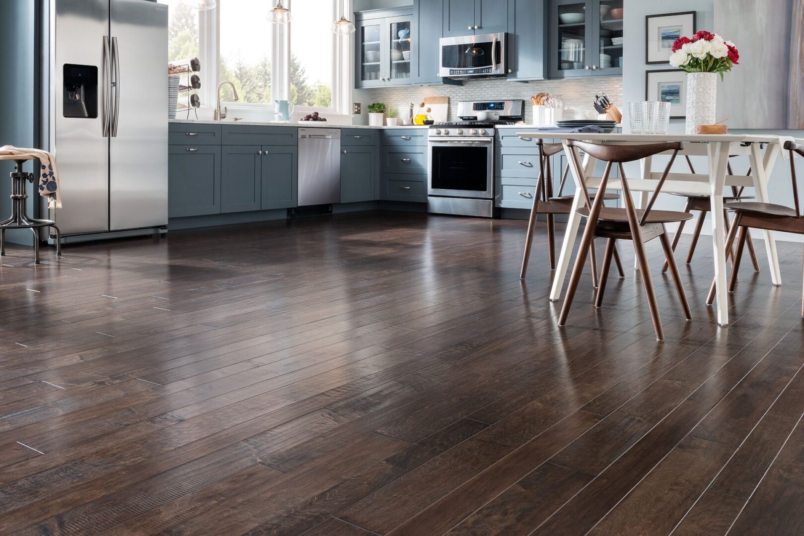 A kitchen with wooden floors and blue cabinets.