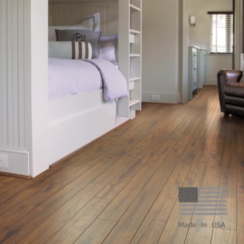 A bedroom with hardwood floors and white walls.