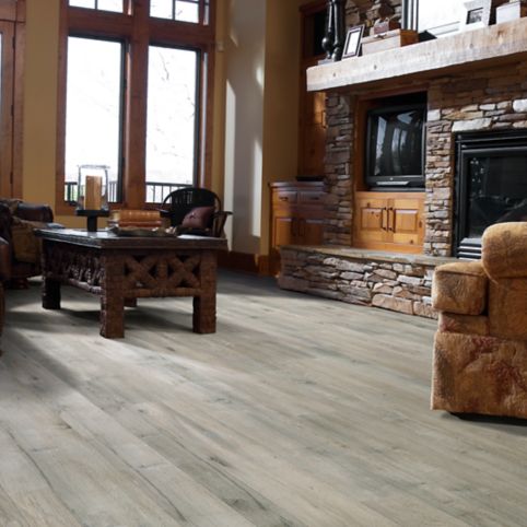 A living room with a fireplace and wooden floors