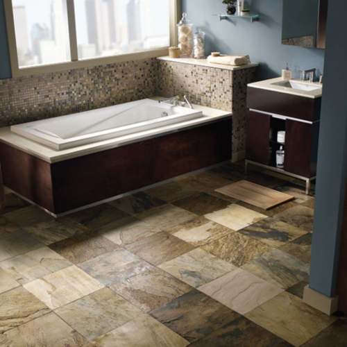 A bathroom with tile floors and a tub.