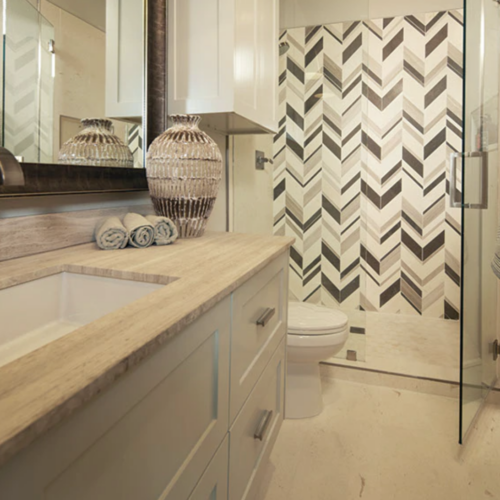 A bathroom with a sink, toilet and shower.