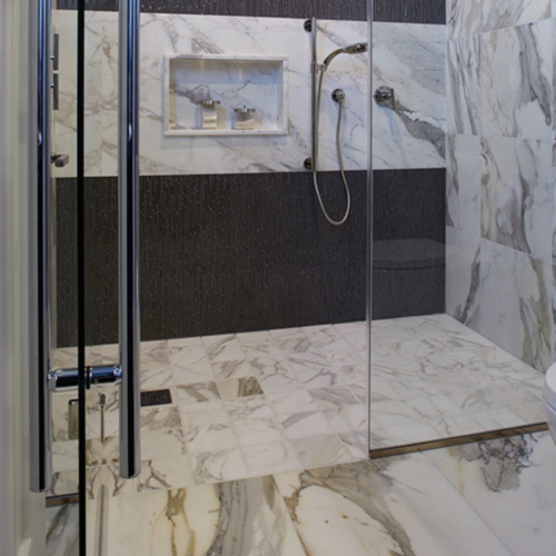 A bathroom with marble walls and floors.