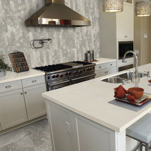 A kitchen with white cabinets and a stove.