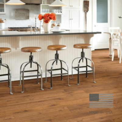 A kitchen with wooden floors and stools in it