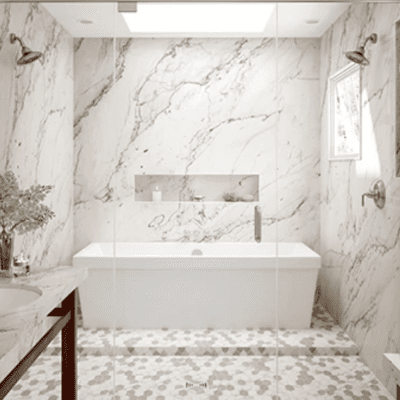 A bathroom with marble walls and floor, and a tub.