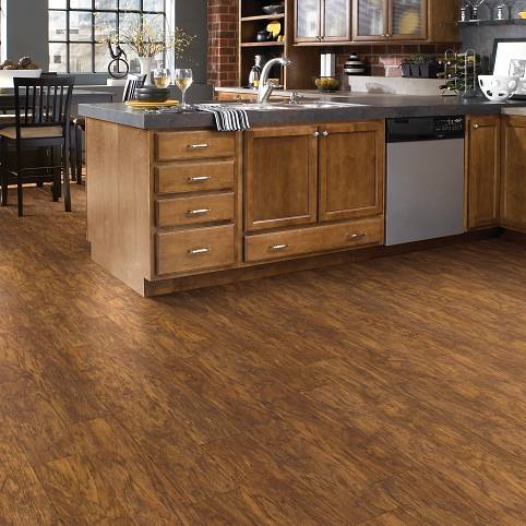 A kitchen with wooden floors and cabinets