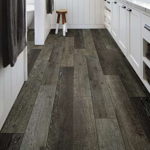 A kitchen with wood floors and white cabinets